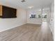 Spacious living room with vinyl flooring and a view into the kitchen at 5084 Misty Canal Pl, Bradenton, FL 34203