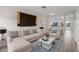 Staged living room, featuring modern furniture and plenty of natural light at 5084 Misty Canal Pl, Bradenton, FL 34203