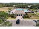 Aerial view of a community pool and clubhouse with palm trees and ample seating at 5084 Misty Canal Pl, Bradenton, FL 34203