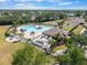 Aerial view of a community pool, clubhouse, and tennis courts at 5084 Misty Canal Pl, Bradenton, FL 34203