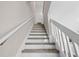 Staircase with wood treads and white risers and railings at 5084 Misty Canal Pl, Bradenton, FL 34203