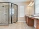 Well-lit bathroom featuring a glass shower and a granite countertop vanity with a mirror and modern lighting fixtures at 5409 Fishhawk Ridge Dr, Lithia, FL 33547