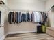 Walk-in closet with wire shelving and hanging rods for ample storage, paired with wood-look floors at 5409 Fishhawk Ridge Dr, Lithia, FL 33547