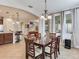 Bright dining area open to the kitchen and living spaces features a dark wood dining table at 5409 Fishhawk Ridge Dr, Lithia, FL 33547