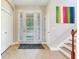 Bright entryway featuring a tiled floor, closet, front door, and staircase at 5409 Fishhawk Ridge Dr, Lithia, FL 33547
