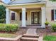 Inviting front entrance with decorative columns and brick-lined steps in a landscaped setting at 5409 Fishhawk Ridge Dr, Lithia, FL 33547