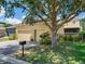 Detached two-car garage featuring lush landscaping, adjacent to a concrete driveway and neighborhood street at 5409 Fishhawk Ridge Dr, Lithia, FL 33547