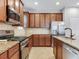 Modern kitchen with stainless steel appliances, granite countertops, and ample cabinet space at 5409 Fishhawk Ridge Dr, Lithia, FL 33547