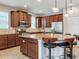 Bright kitchen featuring an island with bar stools, granite countertops, and stainless steel appliances at 5409 Fishhawk Ridge Dr, Lithia, FL 33547
