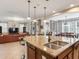 Open-concept view of kitchen with island seating, adjacent to the living room and dining area at 5409 Fishhawk Ridge Dr, Lithia, FL 33547