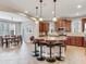 Open kitchen with an island, granite countertops, stainless steel appliances, and adjacent dining area at 5409 Fishhawk Ridge Dr, Lithia, FL 33547