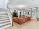Spacious living area with tile floors, large windows, and a staircase at 5409 Fishhawk Ridge Dr, Lithia, FL 33547