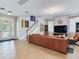 Inviting living room with a stylish staircase, tile flooring, and ample natural light at 5409 Fishhawk Ridge Dr, Lithia, FL 33547