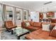 Bright living room with a leather sectional, glass coffee table, and view to the kitchen at 5409 Fishhawk Ridge Dr, Lithia, FL 33547