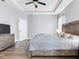Light-filled main bedroom features a tray ceiling, neutral decor and plank flooring at 5409 Fishhawk Ridge Dr, Lithia, FL 33547