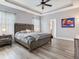 Serene main bedroom with tray ceiling, neutral decor, and wood-look flooring at 5409 Fishhawk Ridge Dr, Lithia, FL 33547