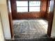 Wood-paneled living room featuring a large window for natural light at 5700 65Th N Ave, Pinellas Park, FL 33781