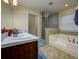 Main bathroom featuring a soaking tub, separate shower, and a single sink vanity at 6216 Evansbrook Dr, Zephyrhills, FL 33541