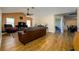 Cozy living room with wood floors, ceiling fan, and view into dining area at 6216 Evansbrook Dr, Zephyrhills, FL 33541