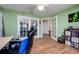 Well-lit office space featuring hardwood floors, a ceiling fan, and French doors leading to other rooms at 6216 Evansbrook Dr, Zephyrhills, FL 33541