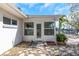 Back of house with stone landscaping and door to a canal at 6321 Balboa Ln, Apollo Beach, FL 33572