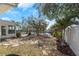 Backyard with mature trees, stone landscaping, and waterfront canal at 6321 Balboa Ln, Apollo Beach, FL 33572