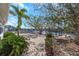 Backyard with mature trees, brick landscaping, and waterfront canal at 6321 Balboa Ln, Apollo Beach, FL 33572