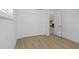 Bright, empty bedroom with hardwood floors, closet, and white walls at 6321 Balboa Ln, Apollo Beach, FL 33572