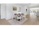 Charming dining area with round wood table, white chairs, and bright natural light at 6321 Balboa Ln, Apollo Beach, FL 33572