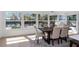 Elegant dining room area with a view to the water and lots of natural light through large windows at 6321 Balboa Ln, Apollo Beach, FL 33572
