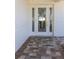 Elegant front door with decorative glass panels and brick-paved entryway, inviting you inside at 6321 Balboa Ln, Apollo Beach, FL 33572