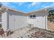 White garage exterior with double doors and AC unit, complemented by a brick walkway at 6321 Balboa Ln, Apollo Beach, FL 33572