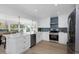 Bright, remodeled kitchen featuring white cabinets, stainless appliances, and an island with seating at 6321 Balboa Ln, Apollo Beach, FL 33572
