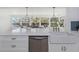Stylish kitchen island with a modern sink and stainless steel appliances, and views of dining area at 6321 Balboa Ln, Apollo Beach, FL 33572