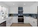 Bright kitchen featuring white cabinetry, stainless steel oven, and complementary hardware at 6321 Balboa Ln, Apollo Beach, FL 33572