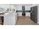 Modern kitchen with white cabinets, stainless steel appliances, and a blue backsplash design at 6321 Balboa Ln, Apollo Beach, FL 33572