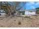 Charming rear exterior with a large stone patio area and well-maintained landscaping at 6321 Balboa Ln, Apollo Beach, FL 33572