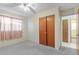 Bedroom with closet, gray carpet, and a window allowing natural light at 6402 Sawyer Rd, Tampa, FL 33634