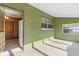 Enclosed patio featuring green walls, tile floors and natural light at 6402 Sawyer Rd, Tampa, FL 33634