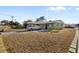 Charming house with spacious lawn, driveway, mature trees, and neutral tone exterior at 6402 Sawyer Rd, Tampa, FL 33634