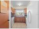 Bright kitchen featuring tile flooring, wooden cabinets, modern appliances, and a sunlit window at 6402 Sawyer Rd, Tampa, FL 33634