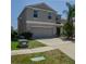 Two-story home with an attached two-car garage, concrete driveway and low-maintenance landscaping at 6707 Blue Moon Way, Sun City Center, FL 33573