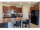 Spacious kitchen featuring granite countertops, stainless steel appliances, and a breakfast bar at 6707 Blue Moon Way, Sun City Center, FL 33573