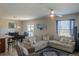 Open-concept living room and dining area, highlighted by a comfortable sectional sofa and lots of natural light at 6707 Blue Moon Way, Sun City Center, FL 33573