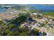 An aerial view reveals the property's waterfront location, bordered by lush greenery and tranquil waters at 6908 11Th E Ave, Palmetto, FL 34221