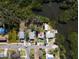 Aerial view of the property highlighting its location near lush vegetation and a waterway at 6908 11Th E Ave, Palmetto, FL 34221