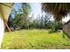 An ample backyard with lush green grass and trees; ideal for outdoor activities at 6908 11Th E Ave, Palmetto, FL 34221