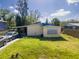 A view of the home featuring a small yard with an unkept lawn at 6908 11Th E Ave, Palmetto, FL 34221