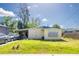 A partial view of a house showing a car port and a car in the driveway at 6908 11Th E Ave, Palmetto, FL 34221