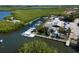 A picturesque view of a marina with boats docked along the pier, surrounded by palm trees and lush vegetation at 6908 11Th E Ave, Palmetto, FL 34221